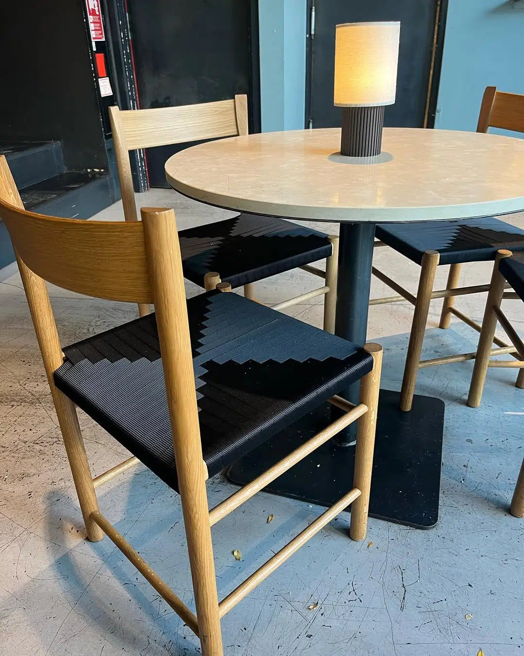 Nyt flet på F Chair med sort kuvertflet og lyst treramme set fra skrå vinkel